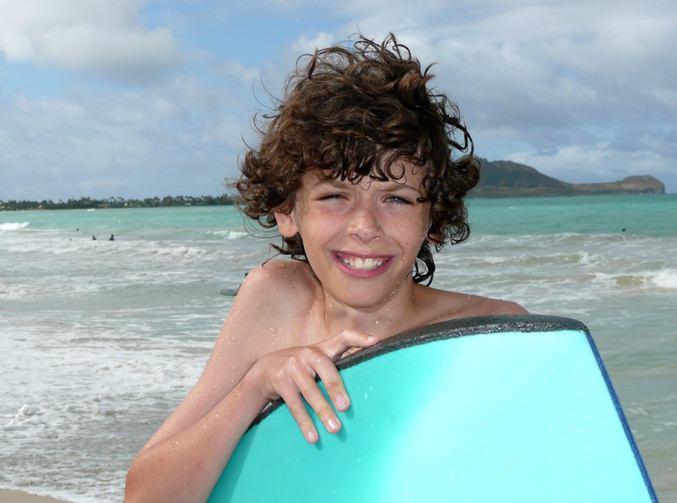 Bo Hessburg takes five after hangin' ten, boogie boarding Kailua Beach on Oahu Island, Hawaii.