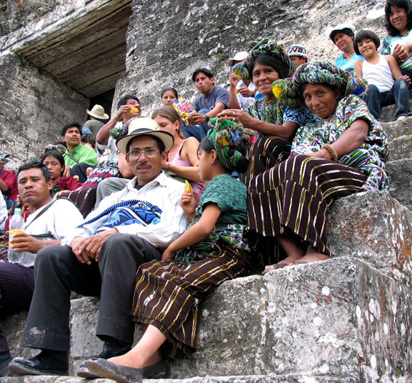 Tikal Ruins, central pyramid, Guatemalan natives in festive garb.