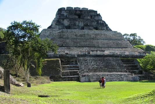 Xunantunich Ruins, central pyramid, guide holds court in golden midday sunshine.